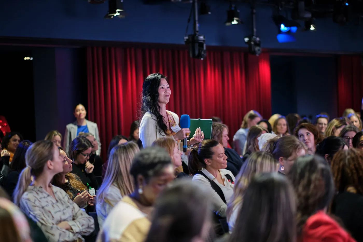 A founder standing to ask a question during a session at Female Founders Raise 2026